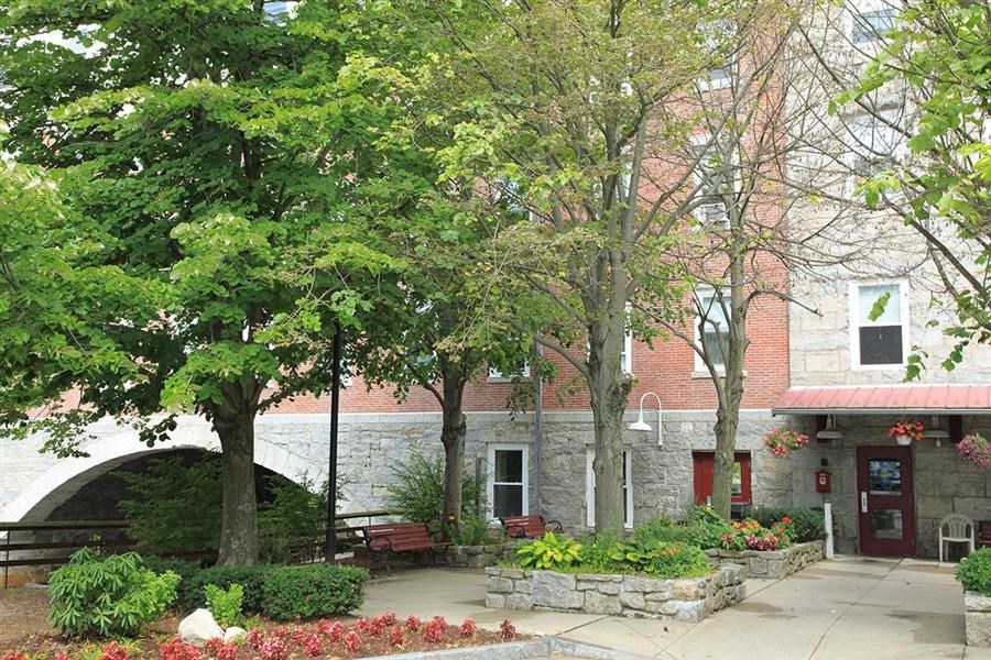 a building with trees and benches in front of it