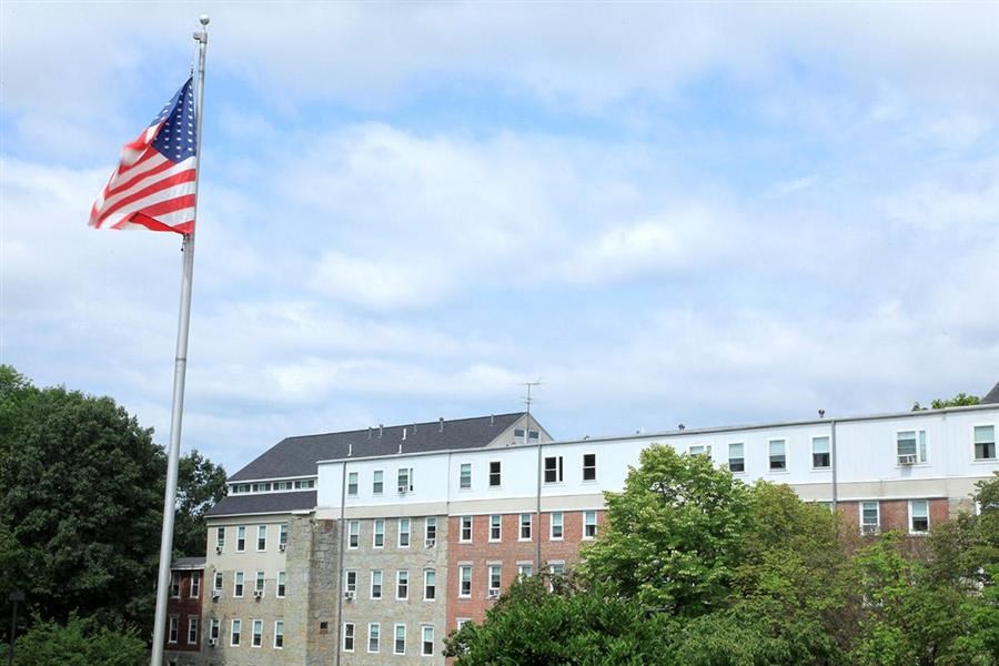 an flag flying in front of a building