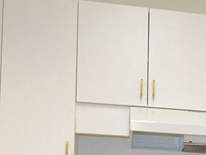 a kitchen with white appliances and white cabinets