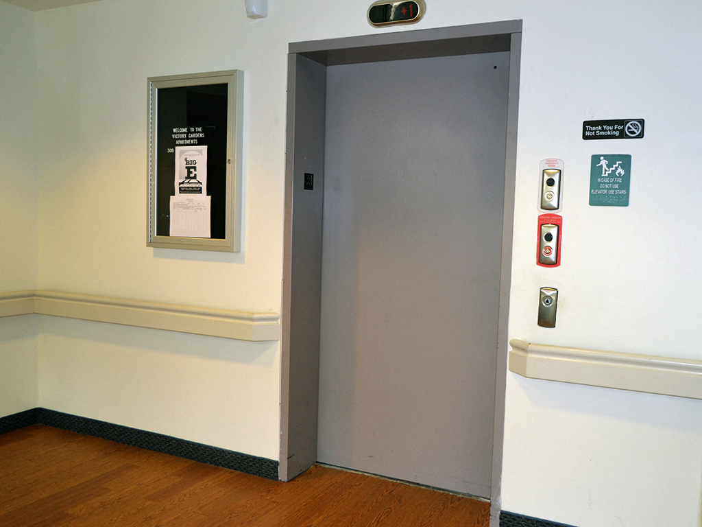 a small door with a window on the side of a wall