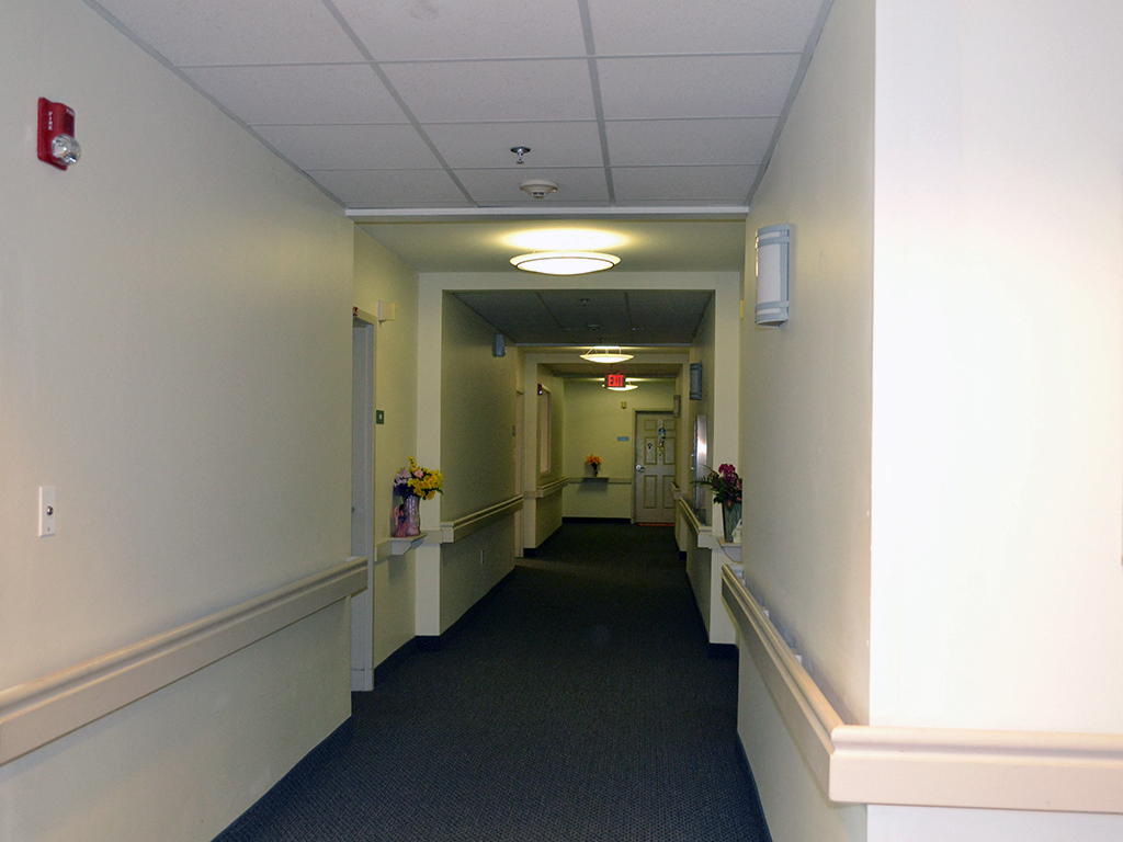 a long corridor with a door at the end of it