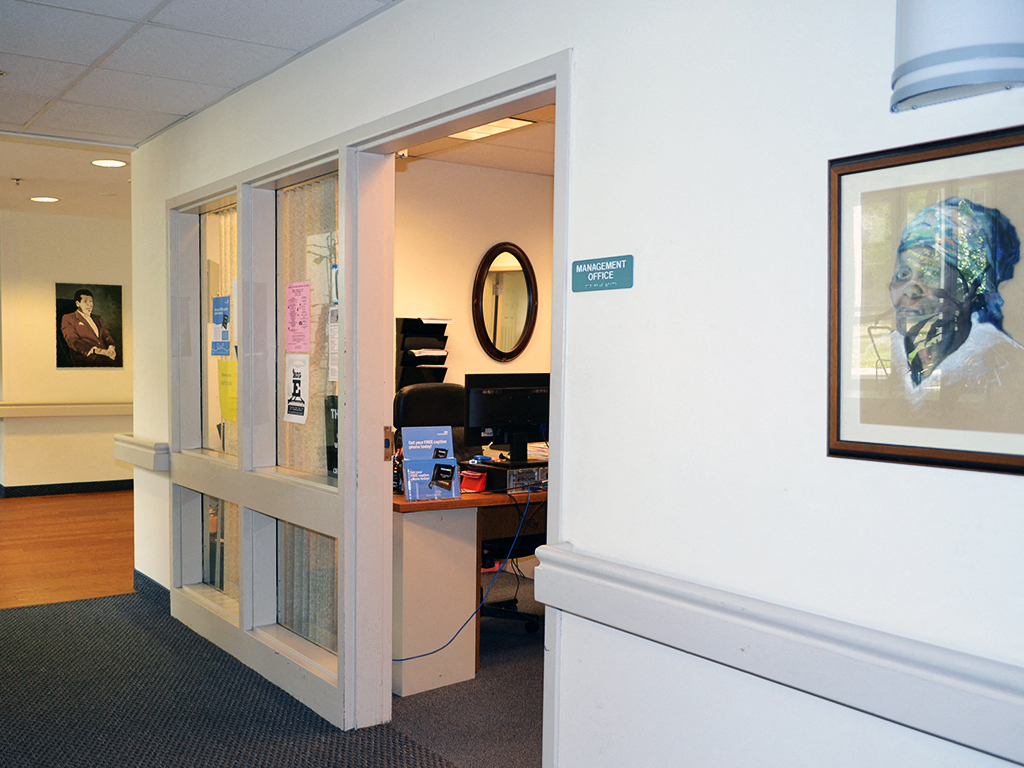 a view into an office with a desk and a window