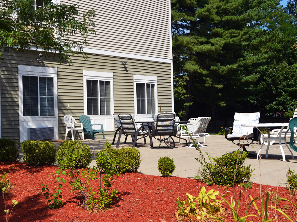 our patio in front of the house with chairs and tables