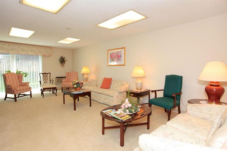 a living room with couches and chairs and a table