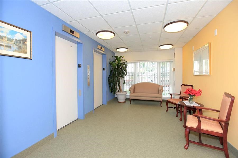 a lobby with chairs and a couch and a table