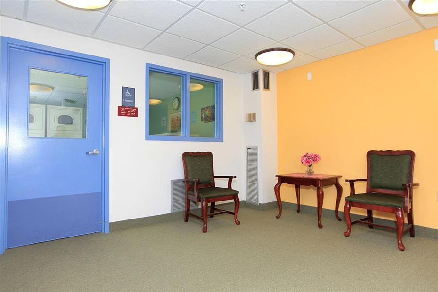 a waiting room with two chairs and a table