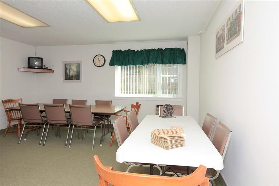 a dining room with a white table and chairs
