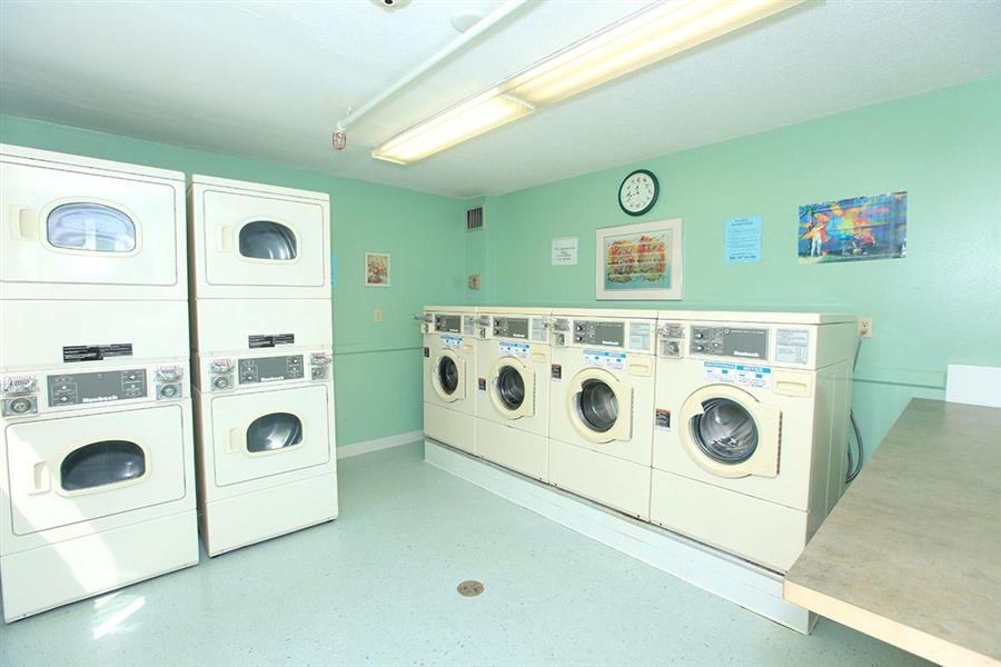 a laundry room with a bunch of washing machines