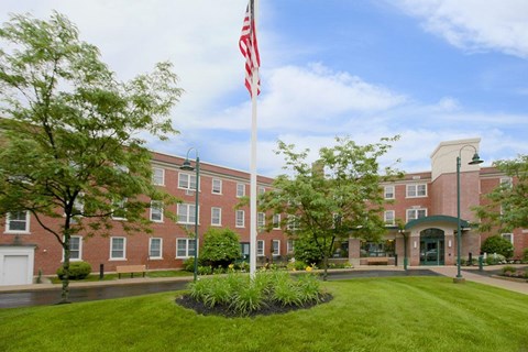 a flagpole with an flag in front of a building