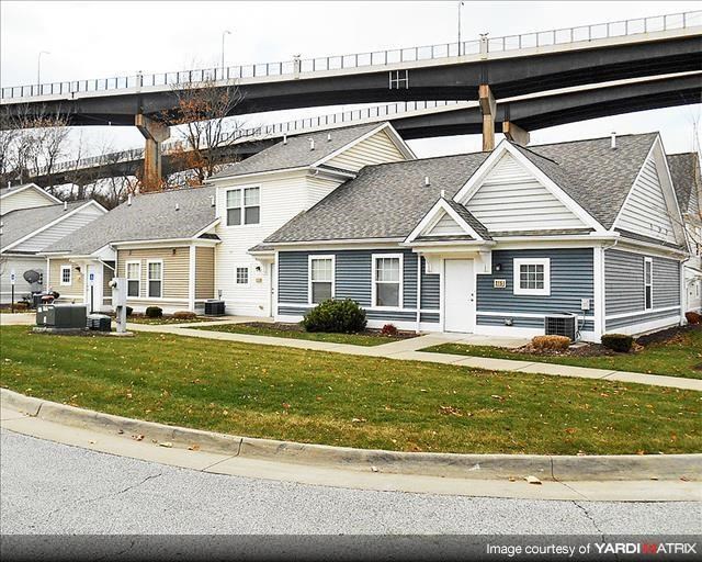 a blue and white house under a bridge