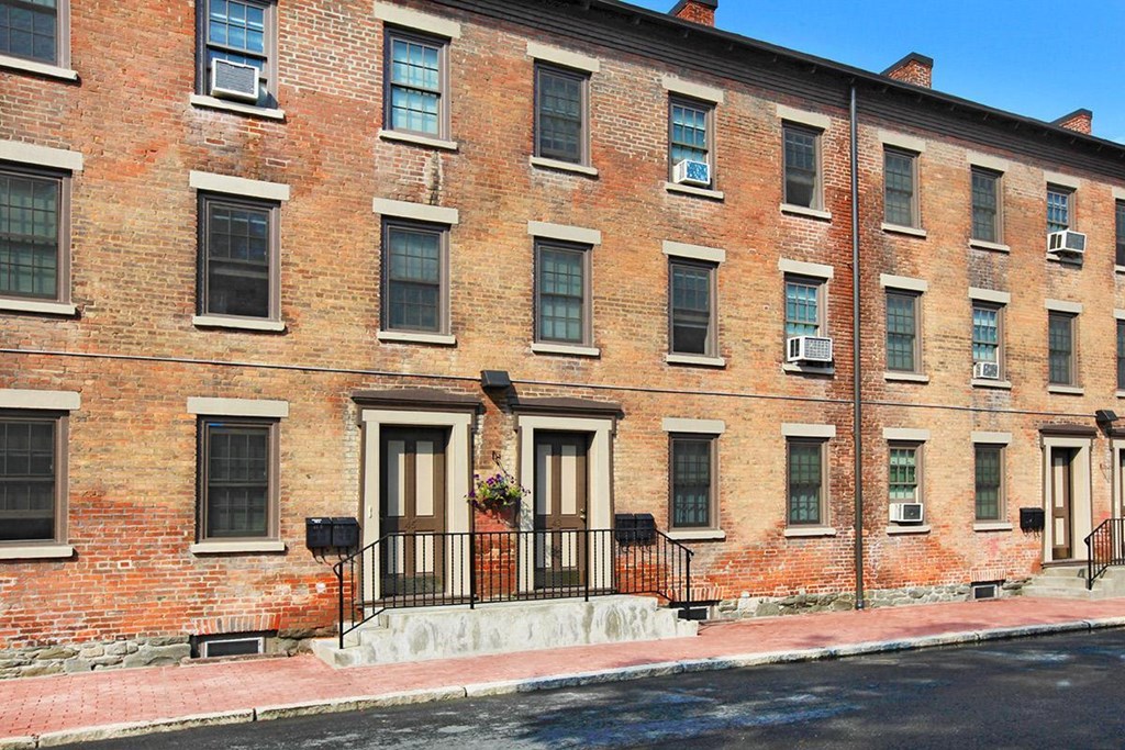 a red brick building with windows and a balcony