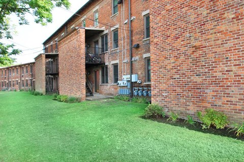 a brick building with green grass in front of it