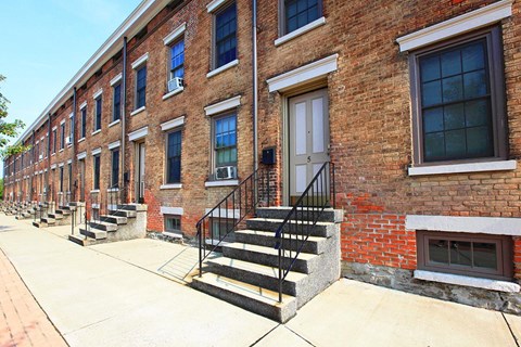 a row of brick apartment buildings with stairs