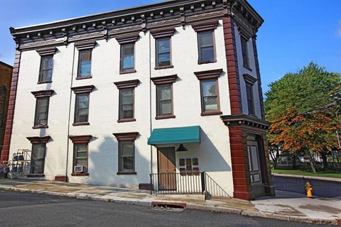 a white building on the corner of a street