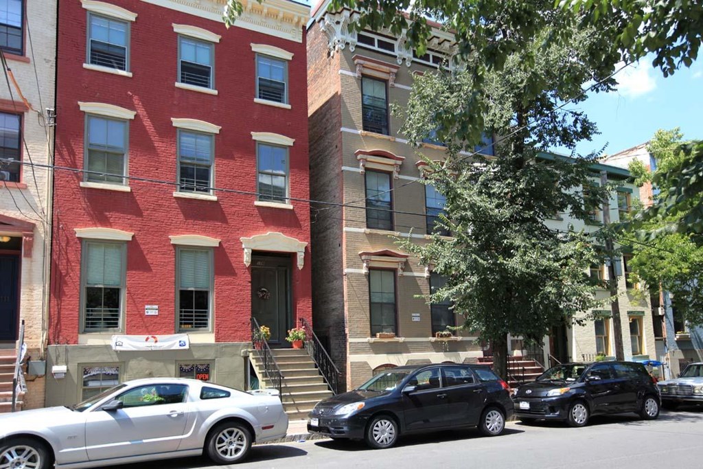 a red brick building with cars parked in front of it