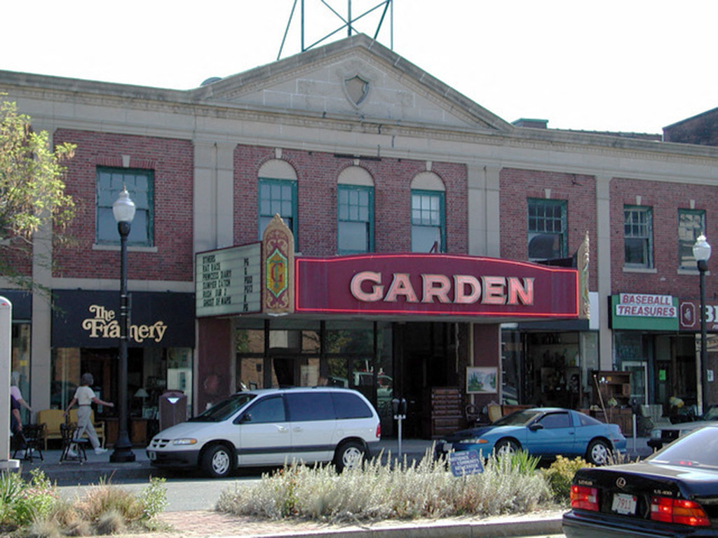a large brick building with a red garden sign