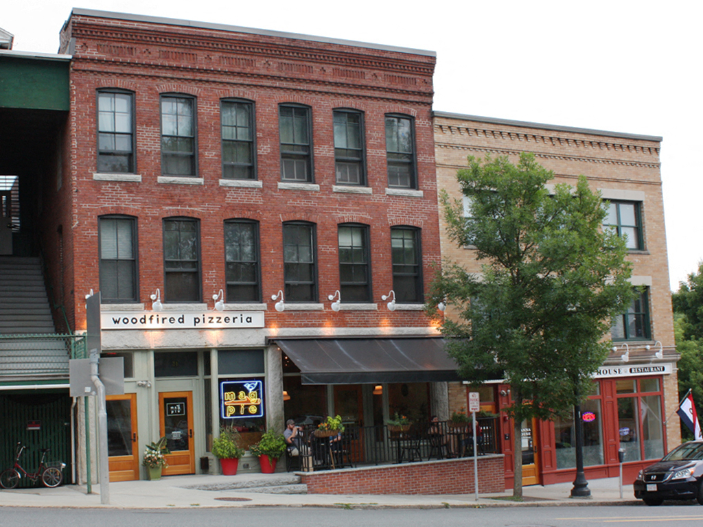 the front of a brick building on a city street