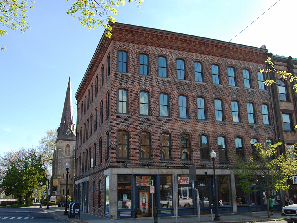 a brick building on the corner of a city street