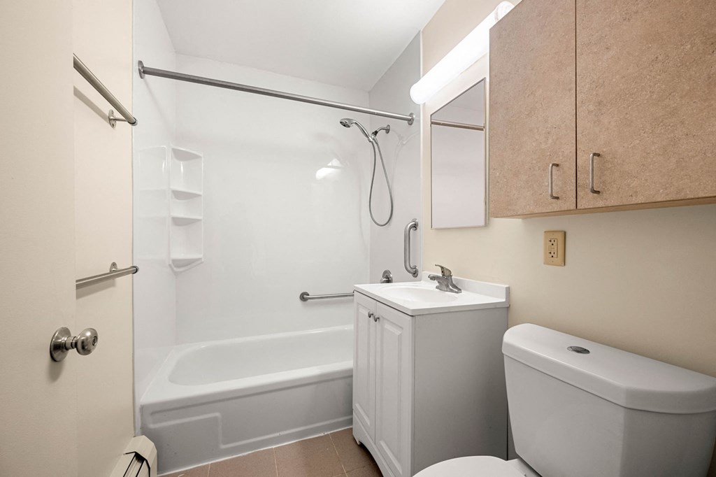 a bathroom with a sink toilet and a bath tub