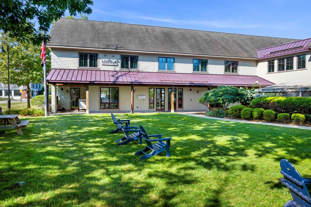 a group of lawn chairs in front of a building