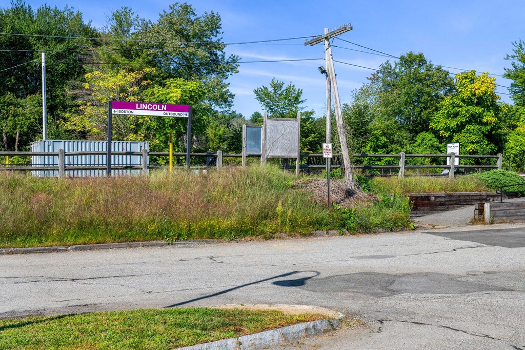 the entrance to the industrial park at the intersection of a road and a fence