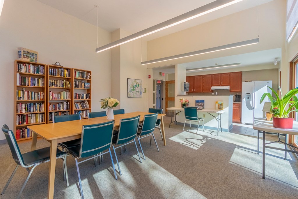 a dining room with a table and chairs and a kitchen
