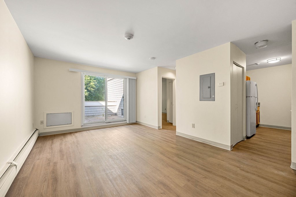 the living room of an empty house with a door to a patio