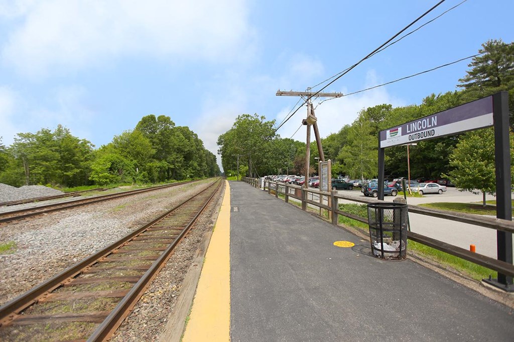the train station on the side of the tracks