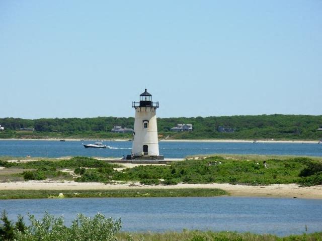 a lighthouse on the shore of a body of water