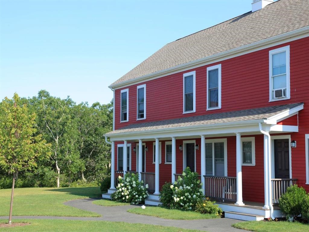 a red house with white flowers in front of it