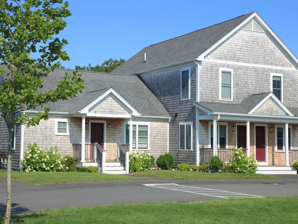 a house with a parking lot in front of it