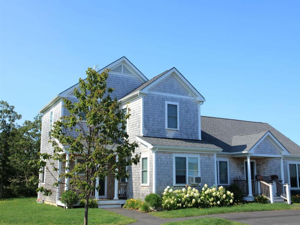 a blue house with a tree in front of it