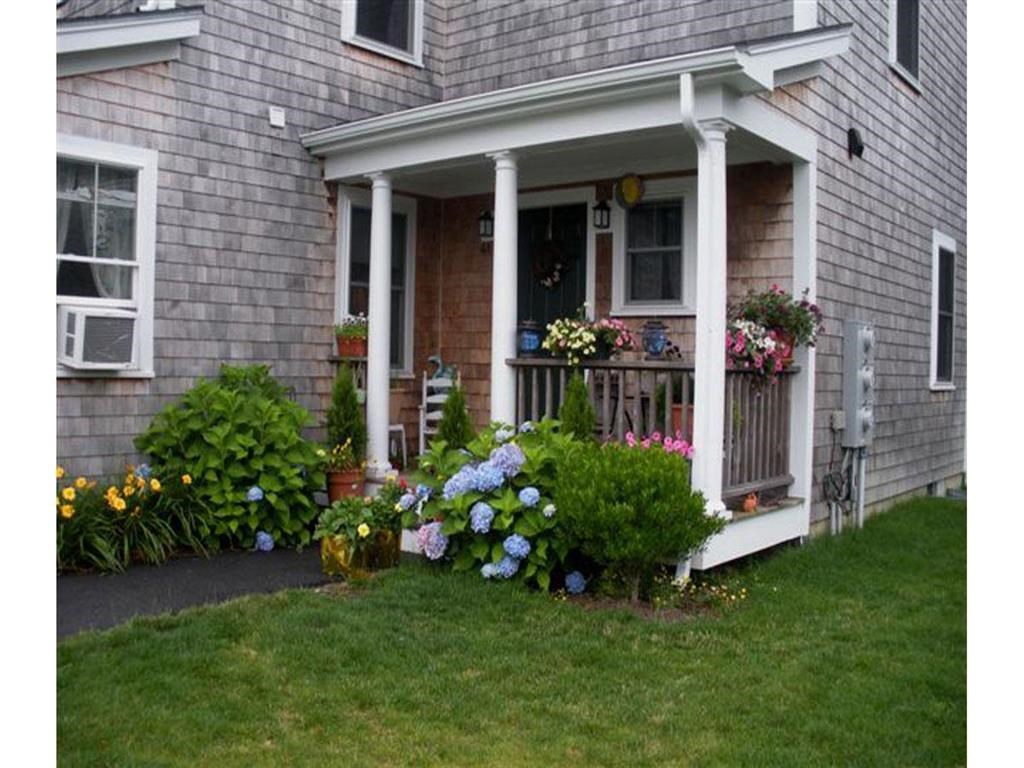a house with a porch and flowers on it