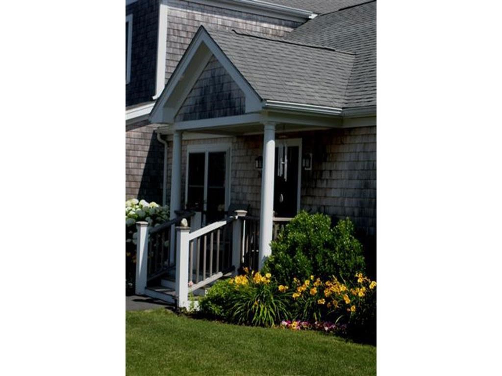a front porch of a house with a porch swing
