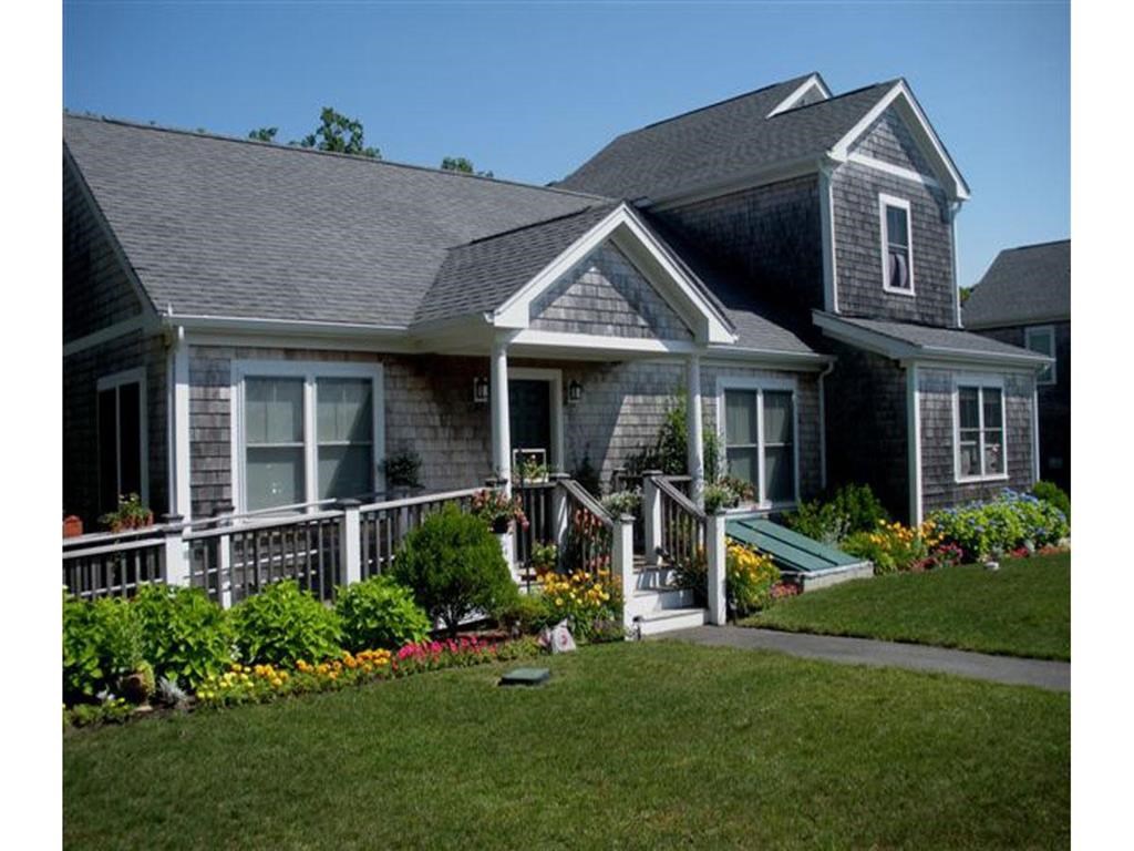 a house with a porch and a lawn