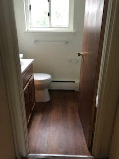 a small bathroom with a toilet and a window