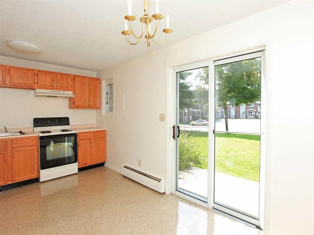 a kitchen with a sliding glass door and a stove