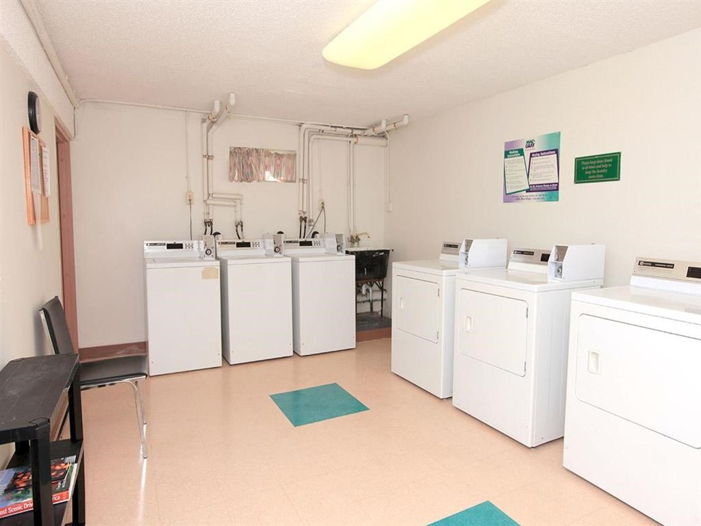 a laundry room filled with washes and dryers