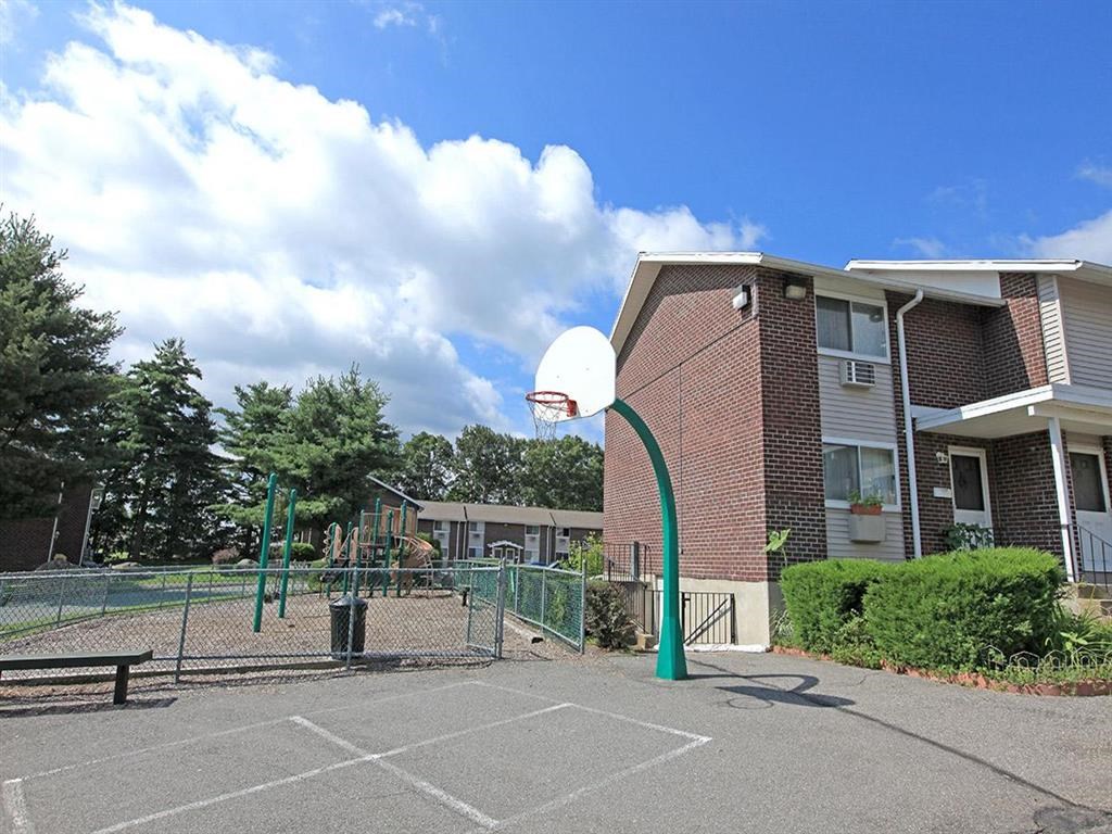 a basketball hoop in a park in front of a building
