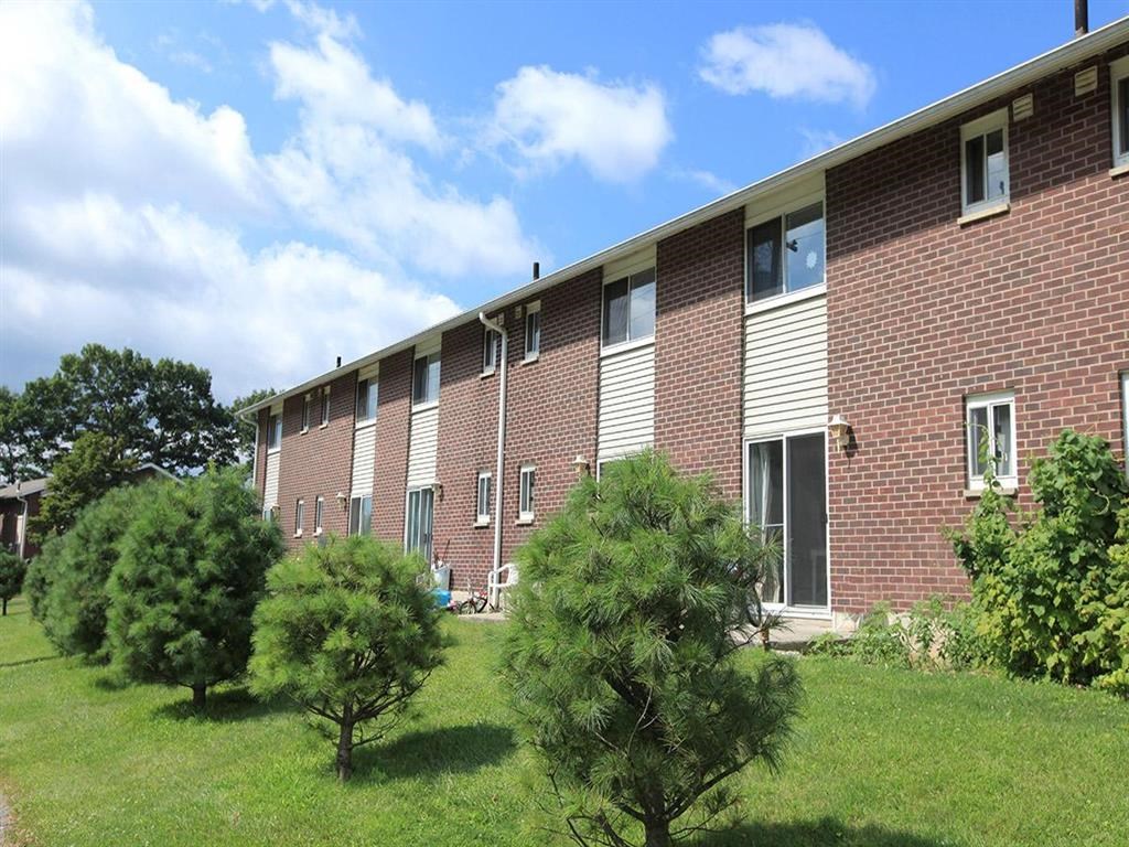 a brick building with trees in front of it