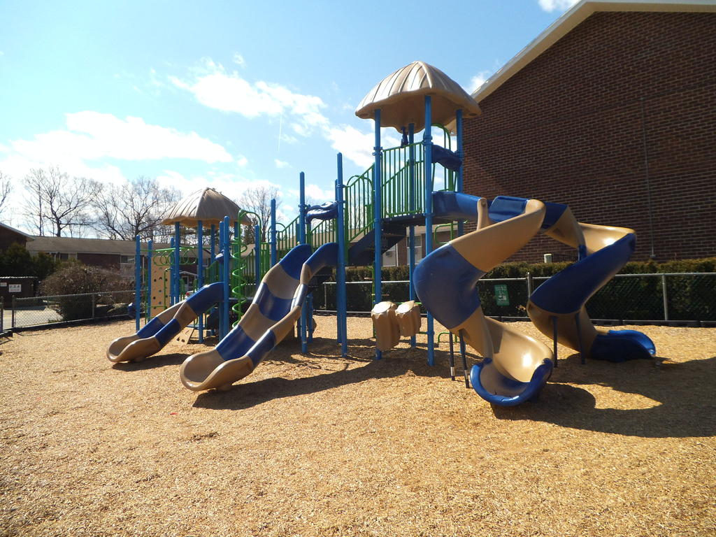 a playground with several slides and a tower