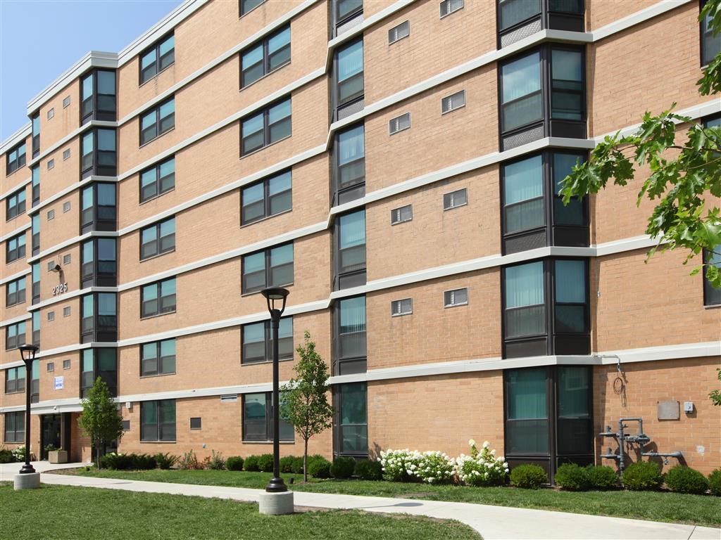 a large brick building with a sidewalk in front of it