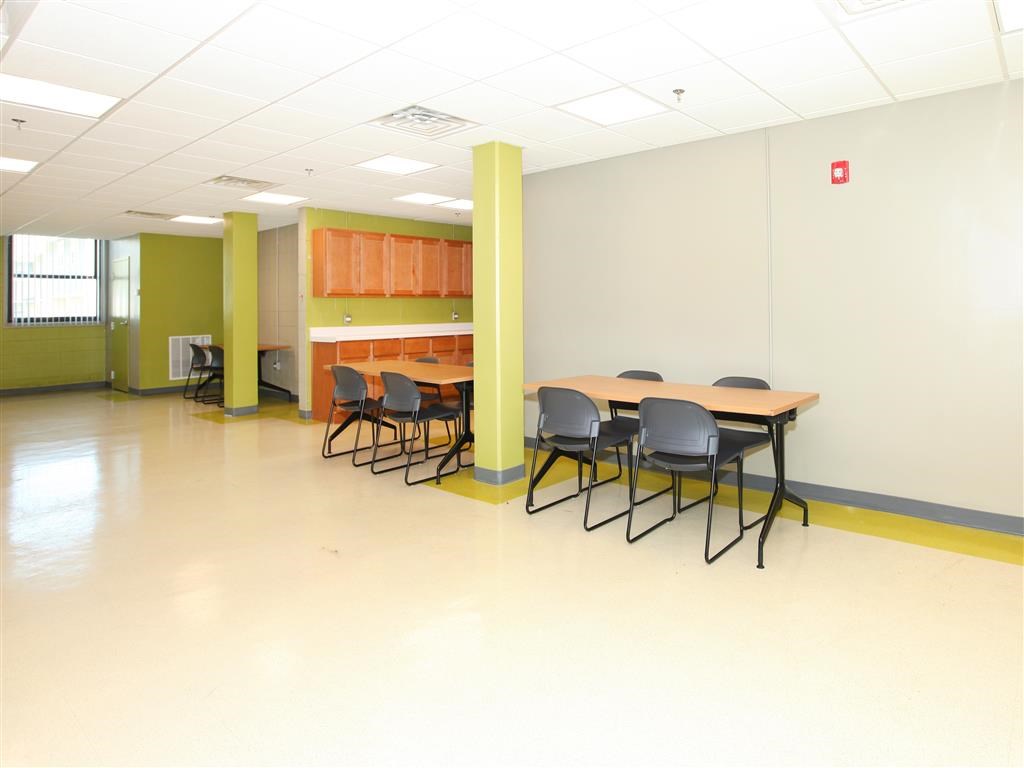 a large room with a table and chairs in it