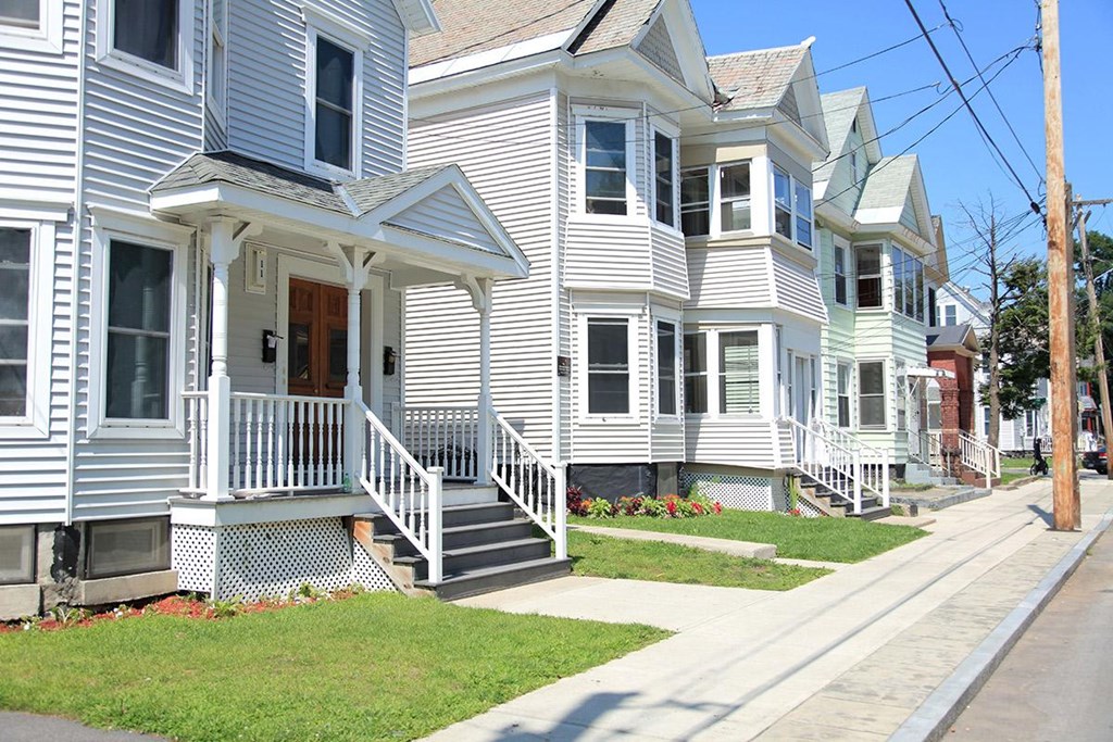 a row of white houses on a sidewalk