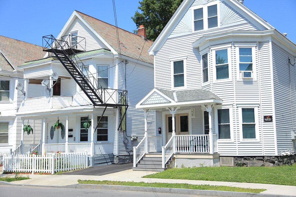 two white houses on the side of a street