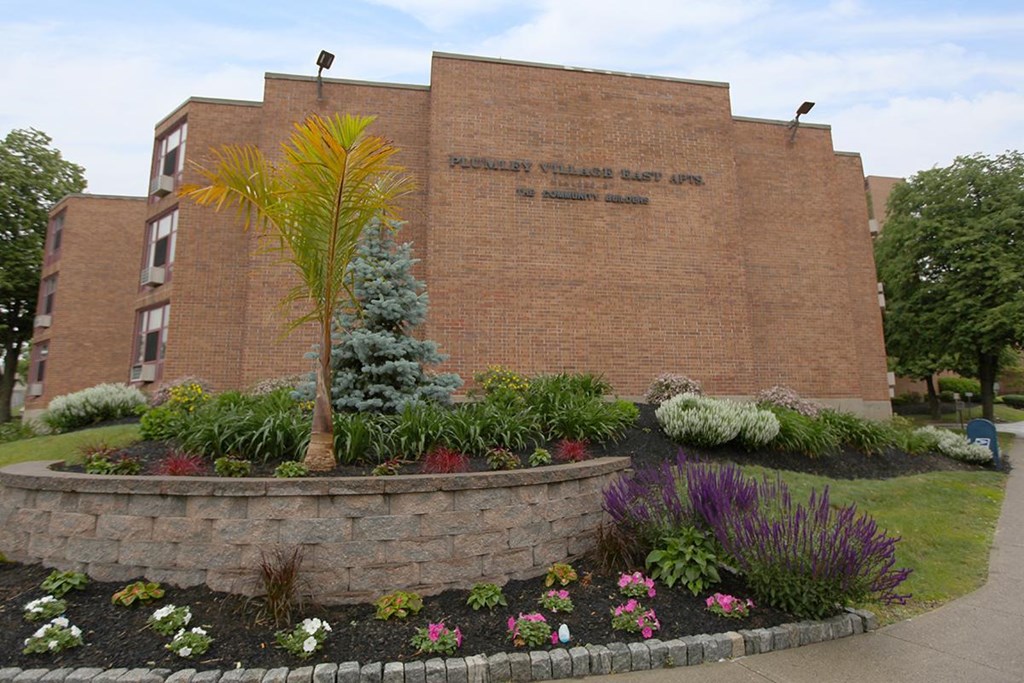 a building with a flower garden in front of it
