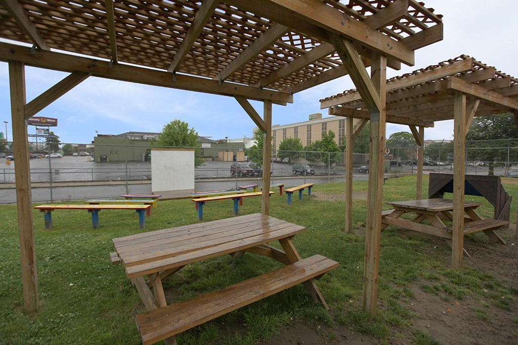 a picnic area with benches and a pergola