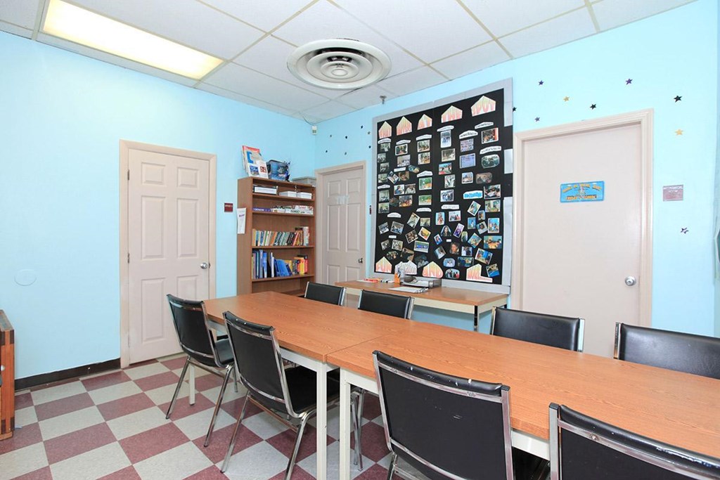 a conference room with a long wooden table and chairs