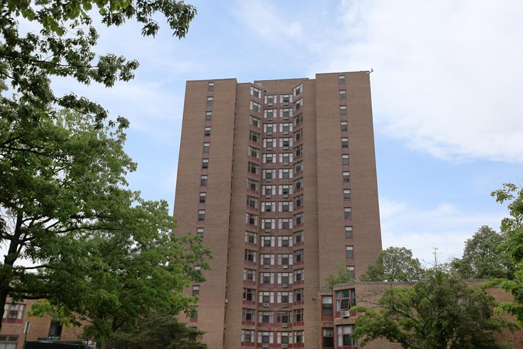 a tall building with many windows and trees
