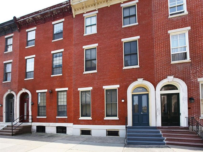 the facade of a brick building with a black door